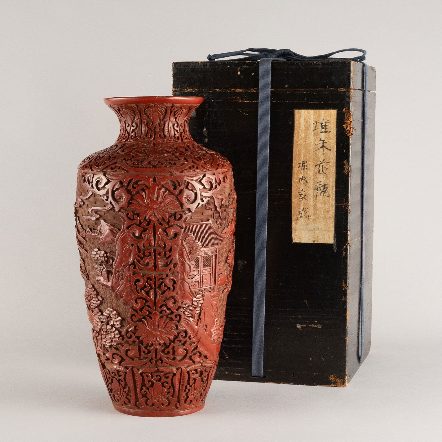 Vermilion-lacquered flower vase with landscape and tower design