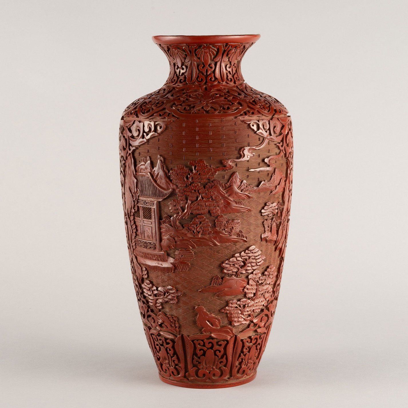Vermilion-lacquered flower vase with landscape and tower design