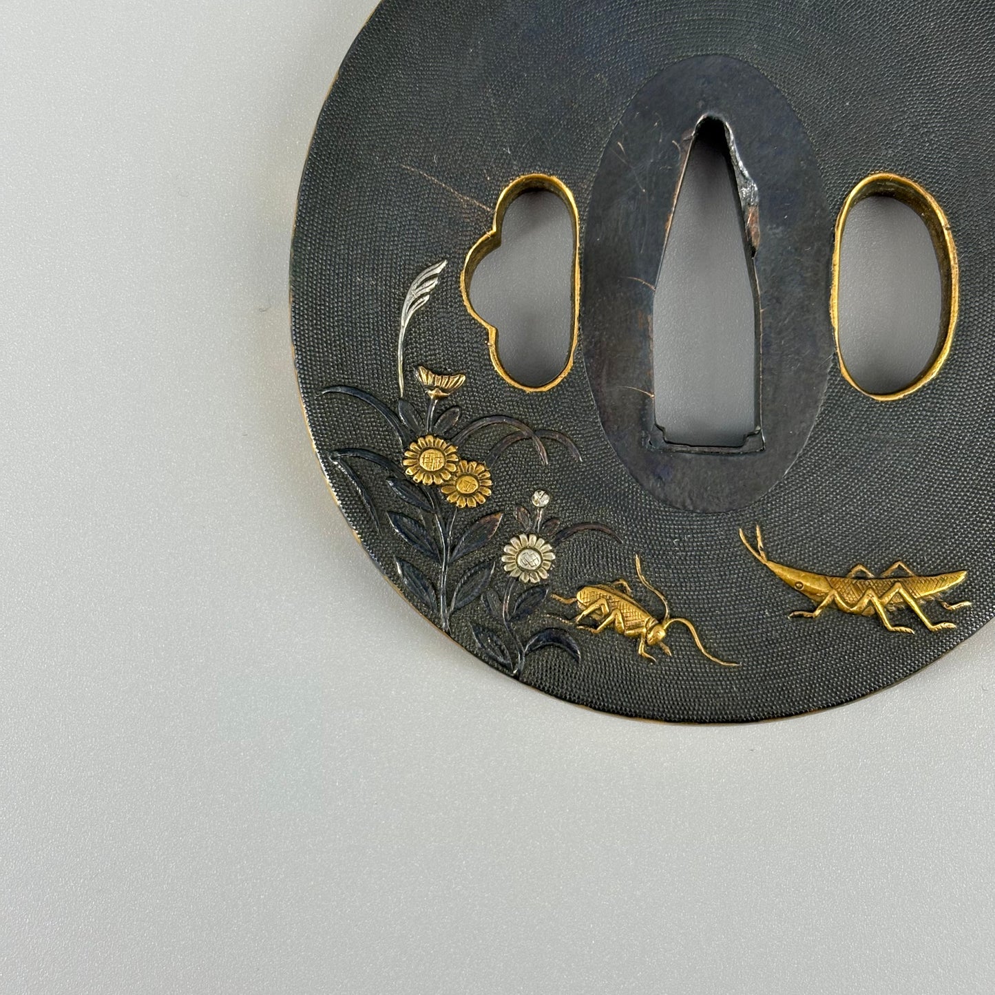 Bird and insect motif sword fittings
