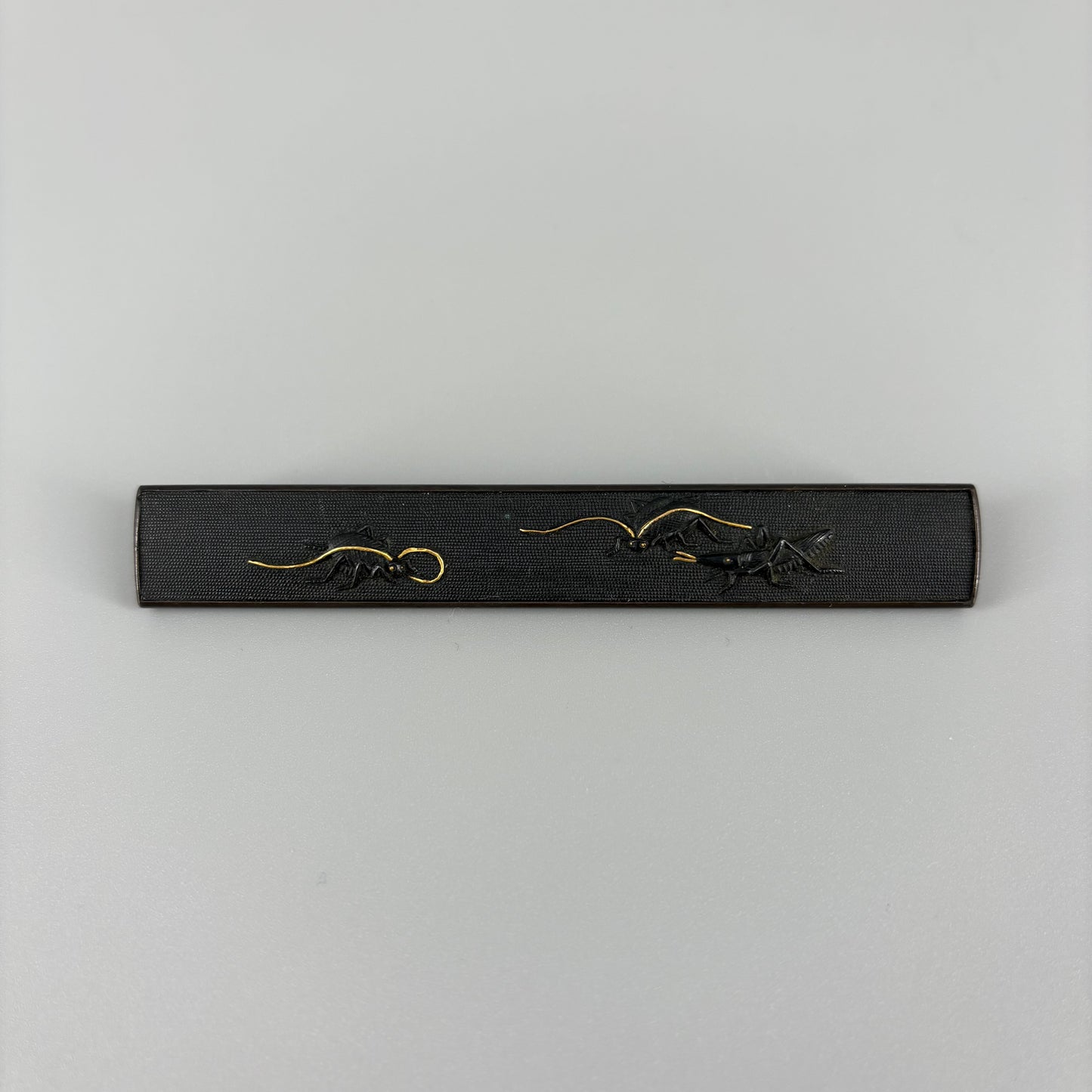 Bird and insect motif sword fittings