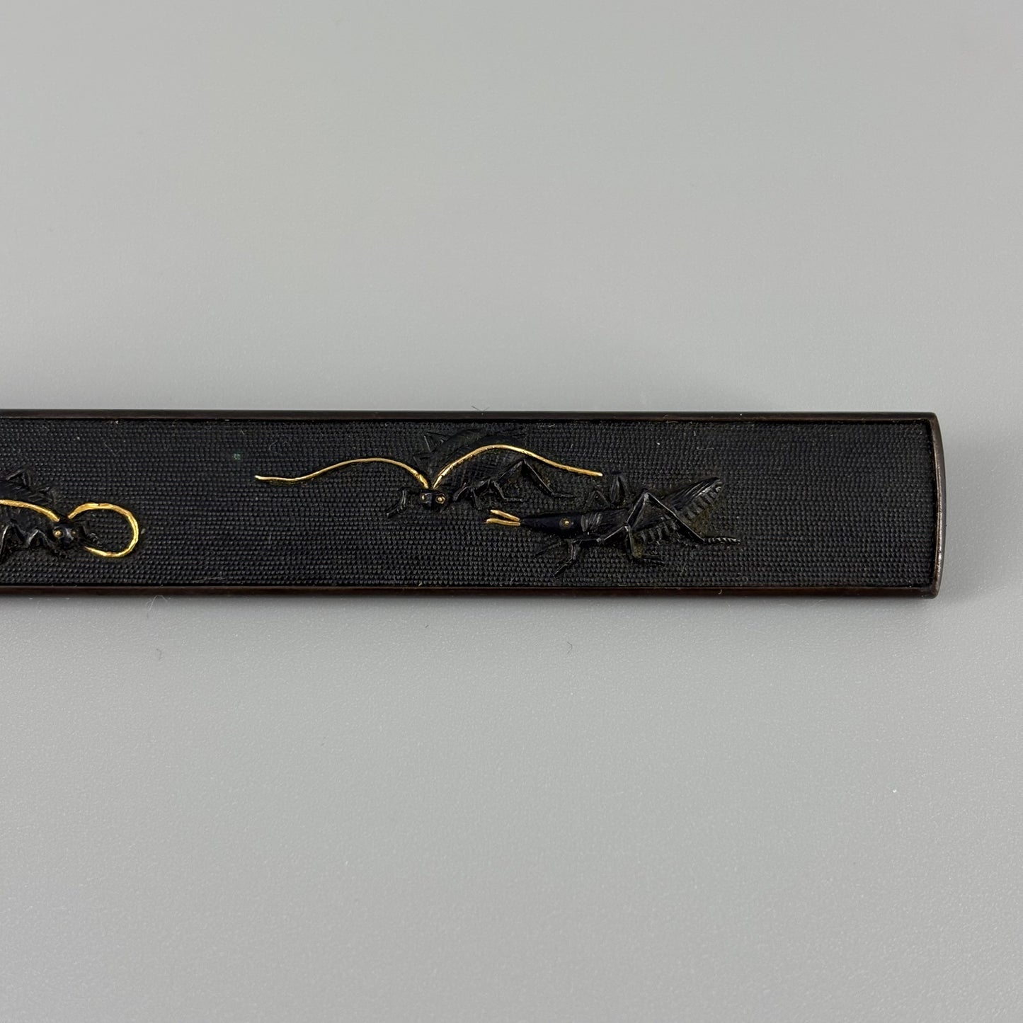 Bird and insect motif sword fittings