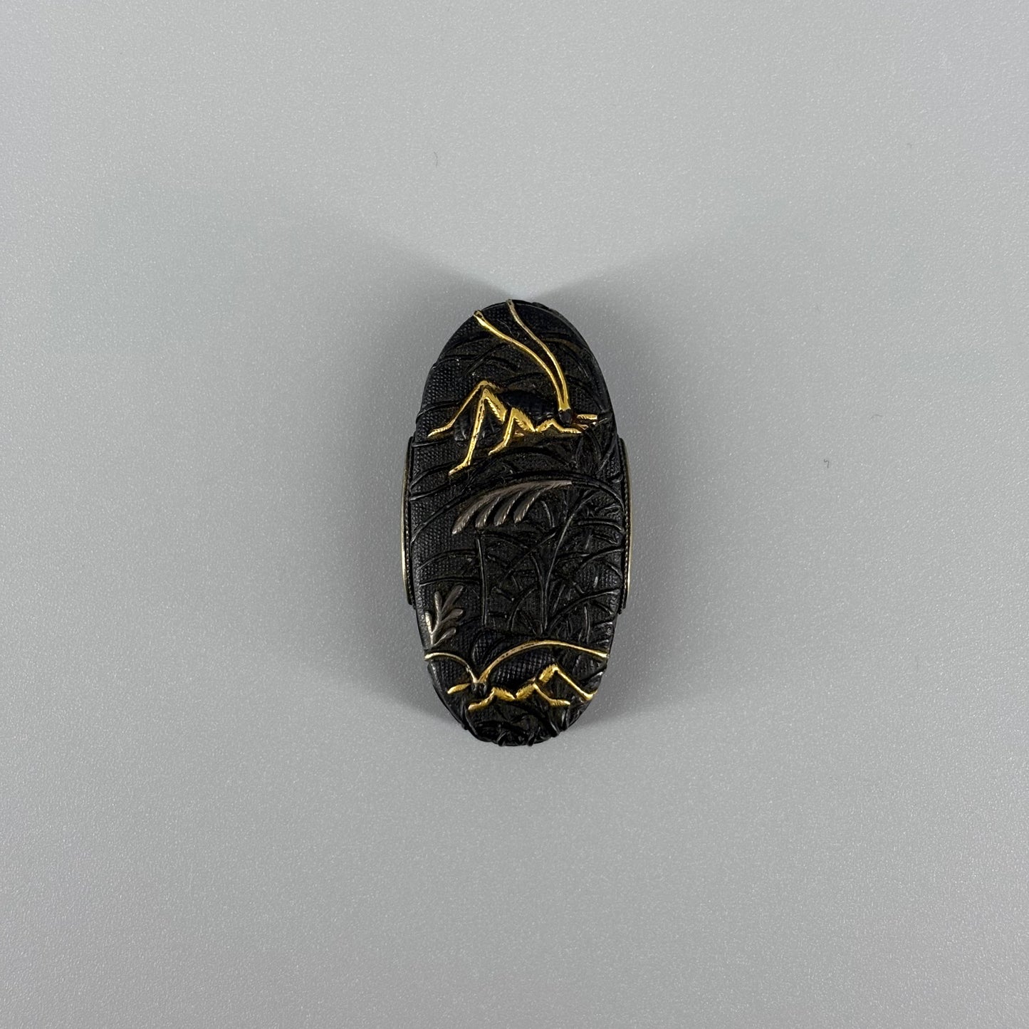 Bird and insect motif sword fittings