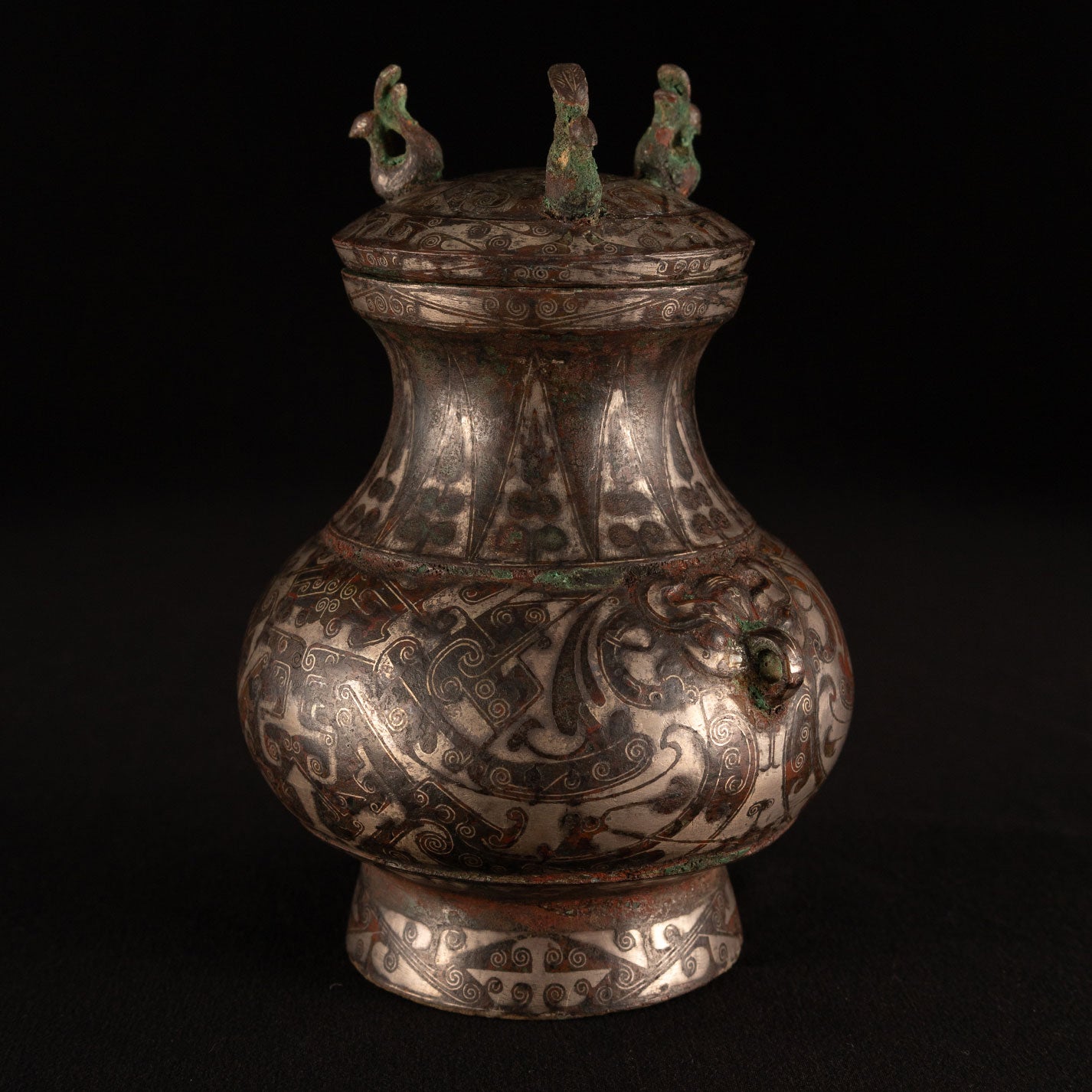Copper-inlaid silver jar with a beast's face