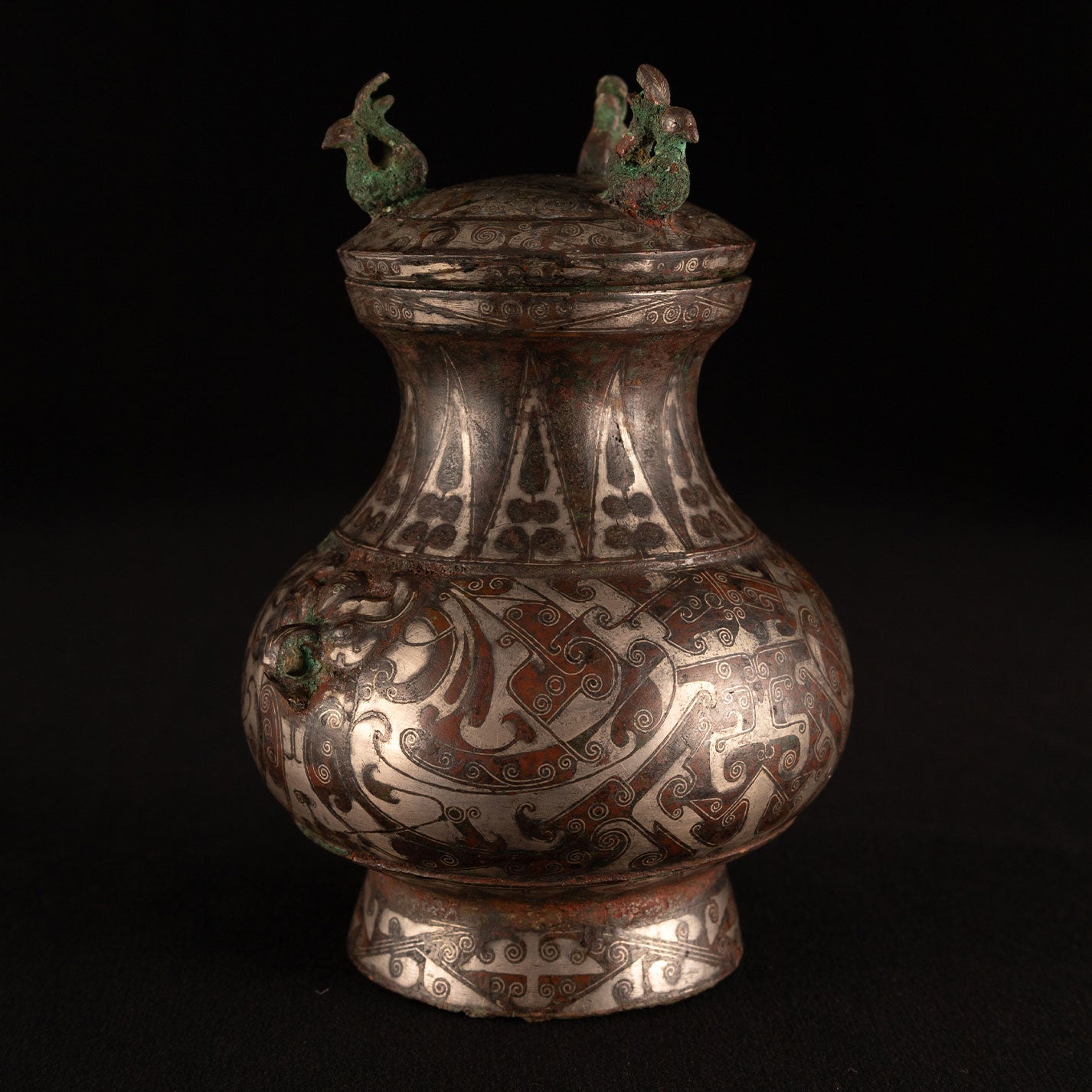 Copper-inlaid silver jar with a beast's face