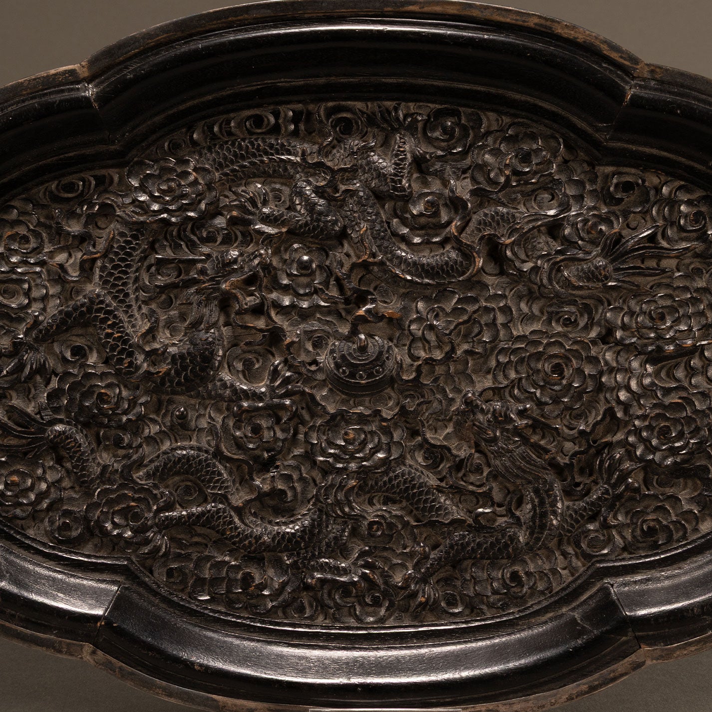 Carved wooden plate with double dragons and begonia motif