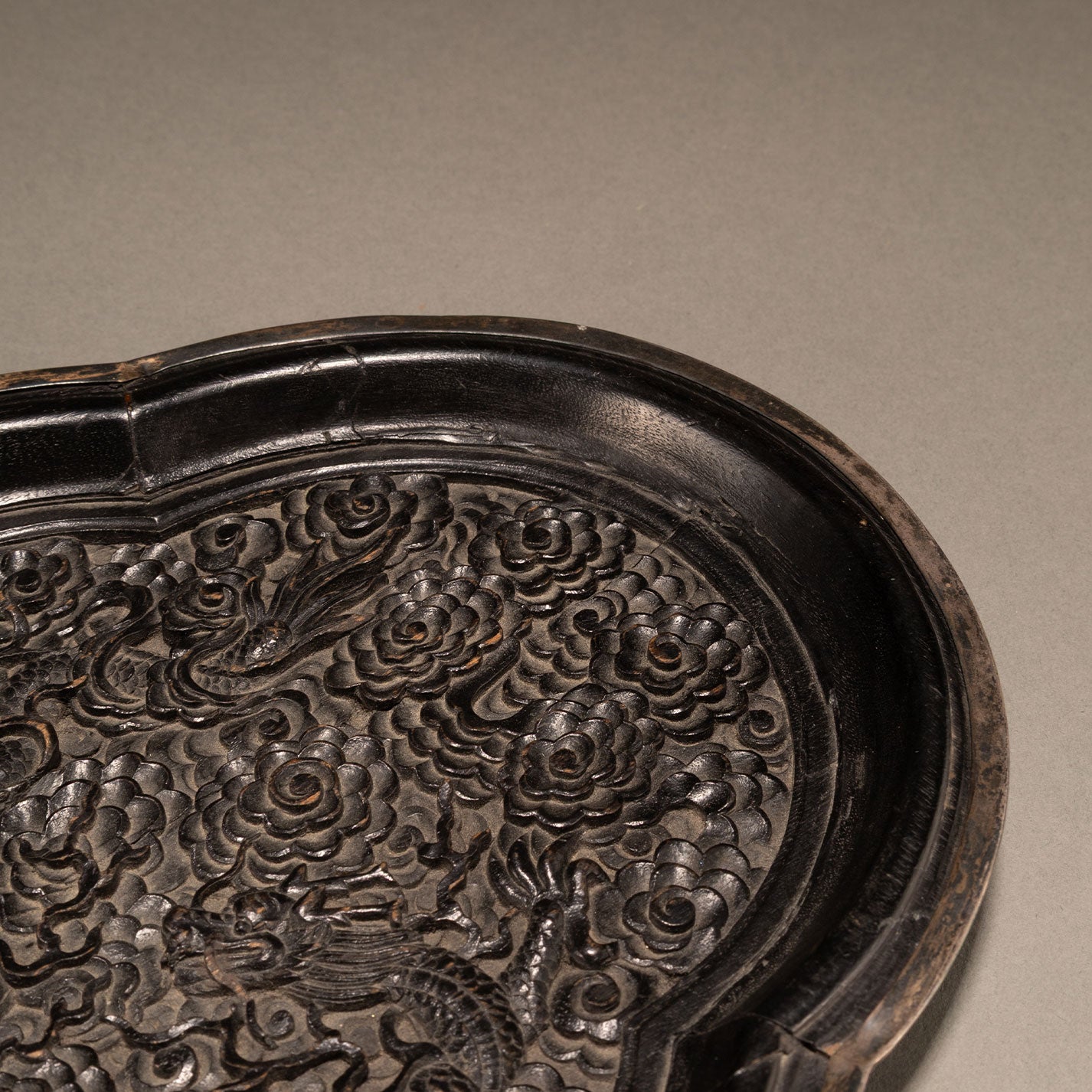 Carved wooden plate with double dragons and begonia motif