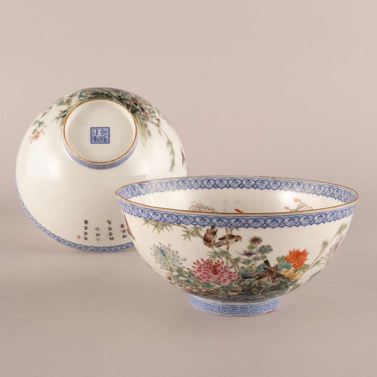 A pair of light-colored flower and bird bowls