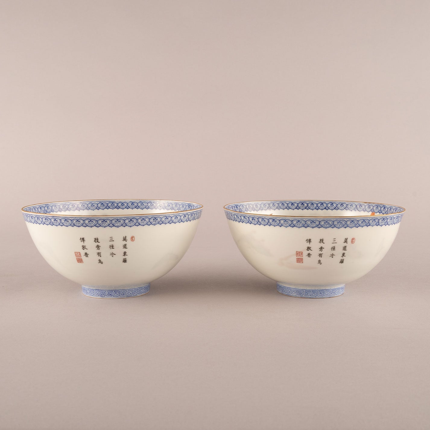 A pair of light-colored flower and bird bowls