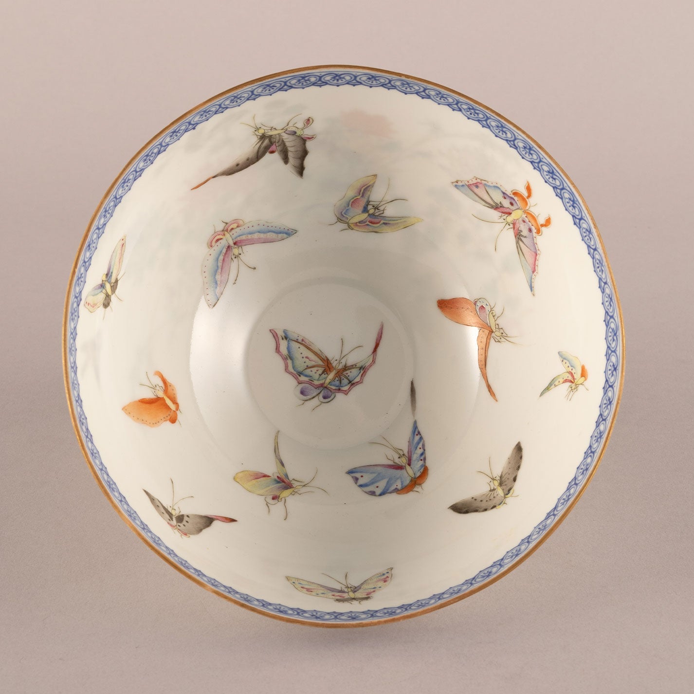 A pair of light-colored flower and bird bowls