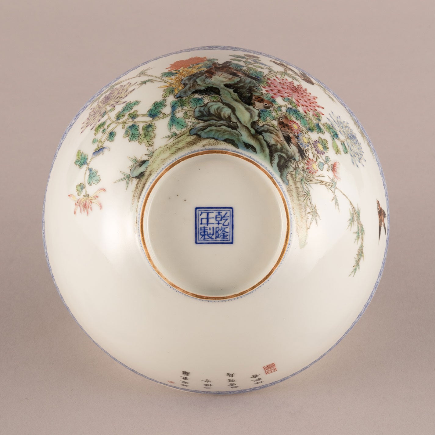 A pair of light-colored flower and bird bowls