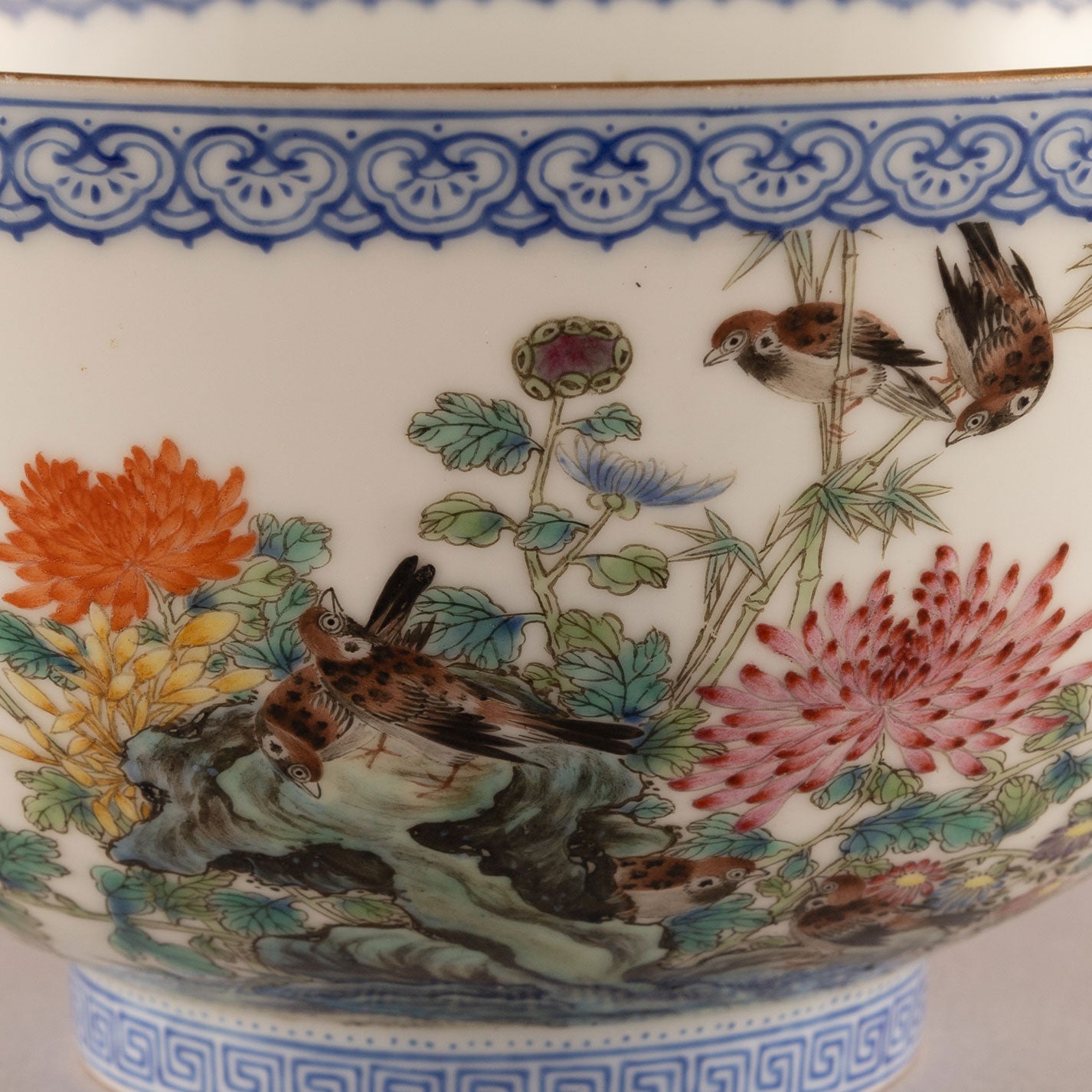 A pair of light-colored flower and bird bowls