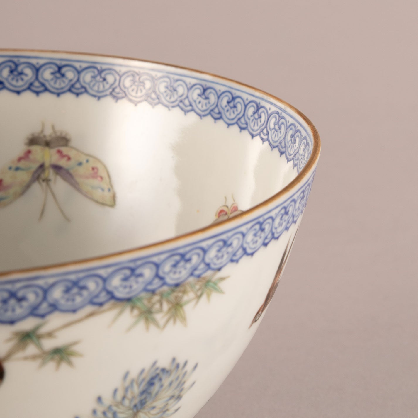 A pair of light-colored flower and bird bowls