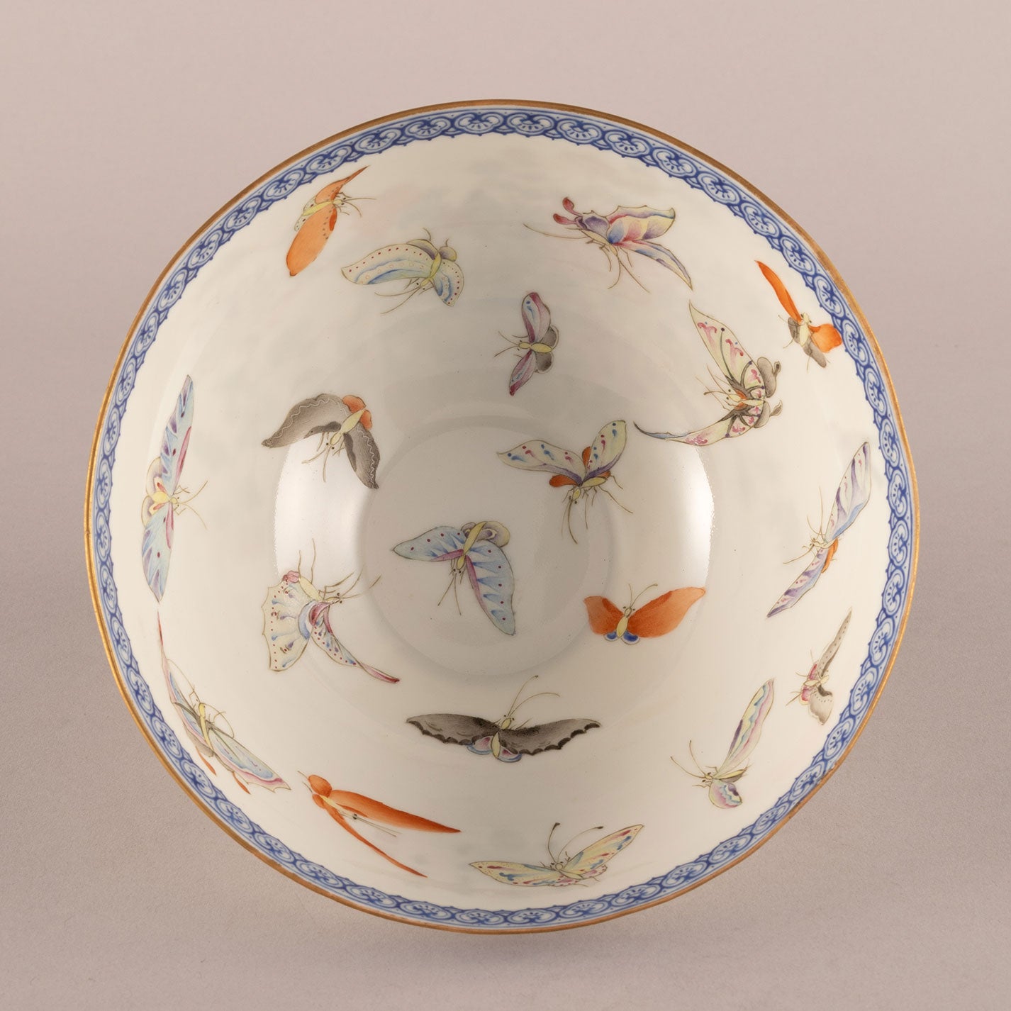 A pair of light-colored flower and bird bowls