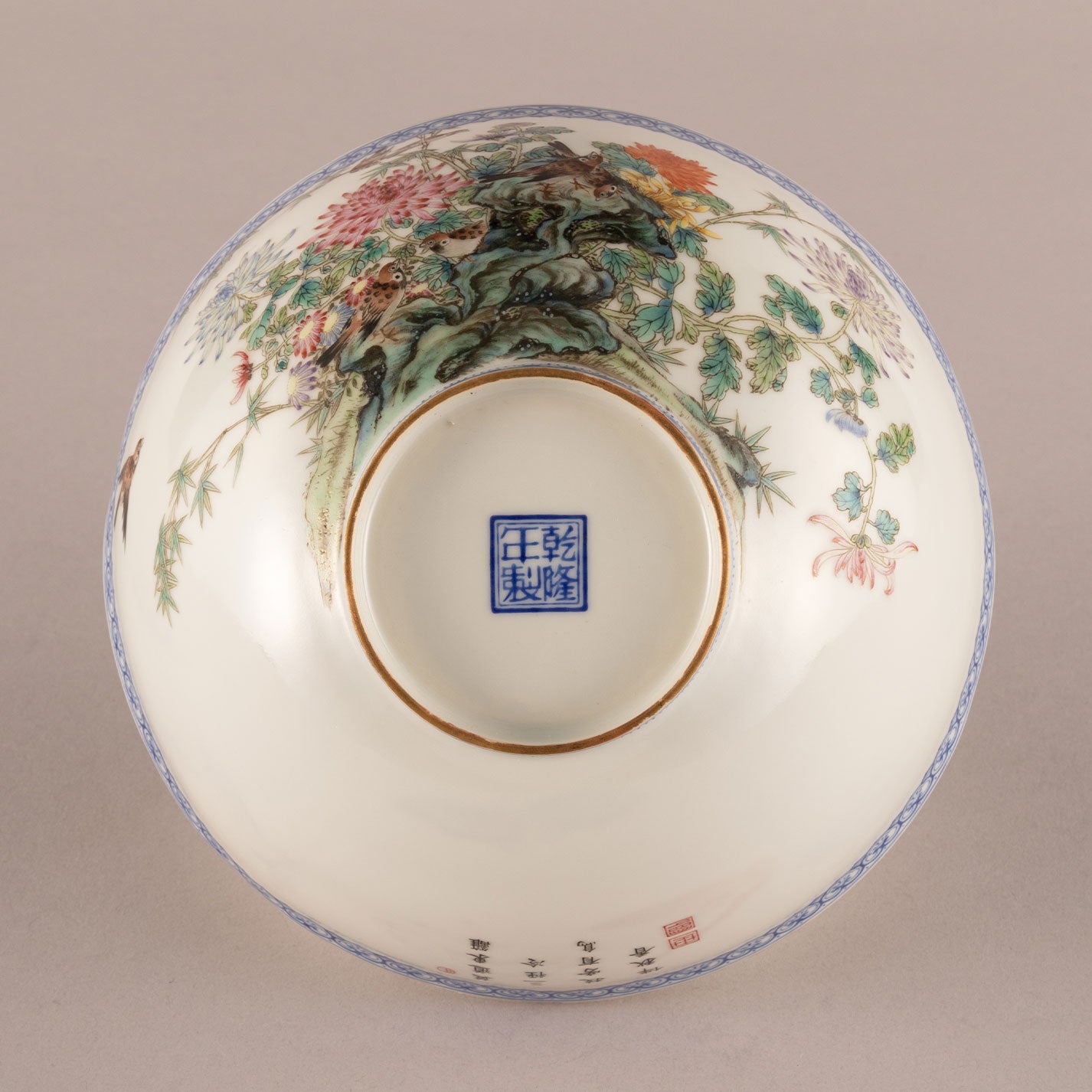 A pair of light-colored flower and bird bowls