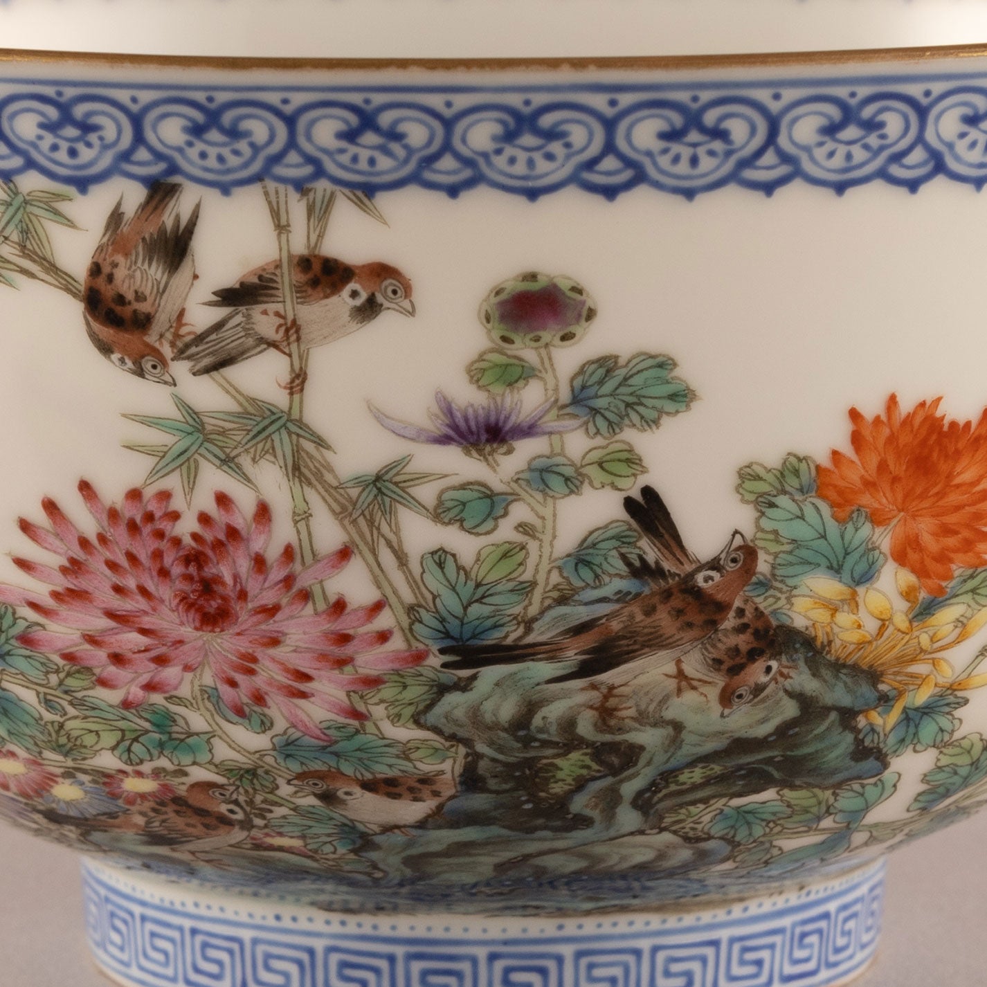 A pair of light-colored flower and bird bowls