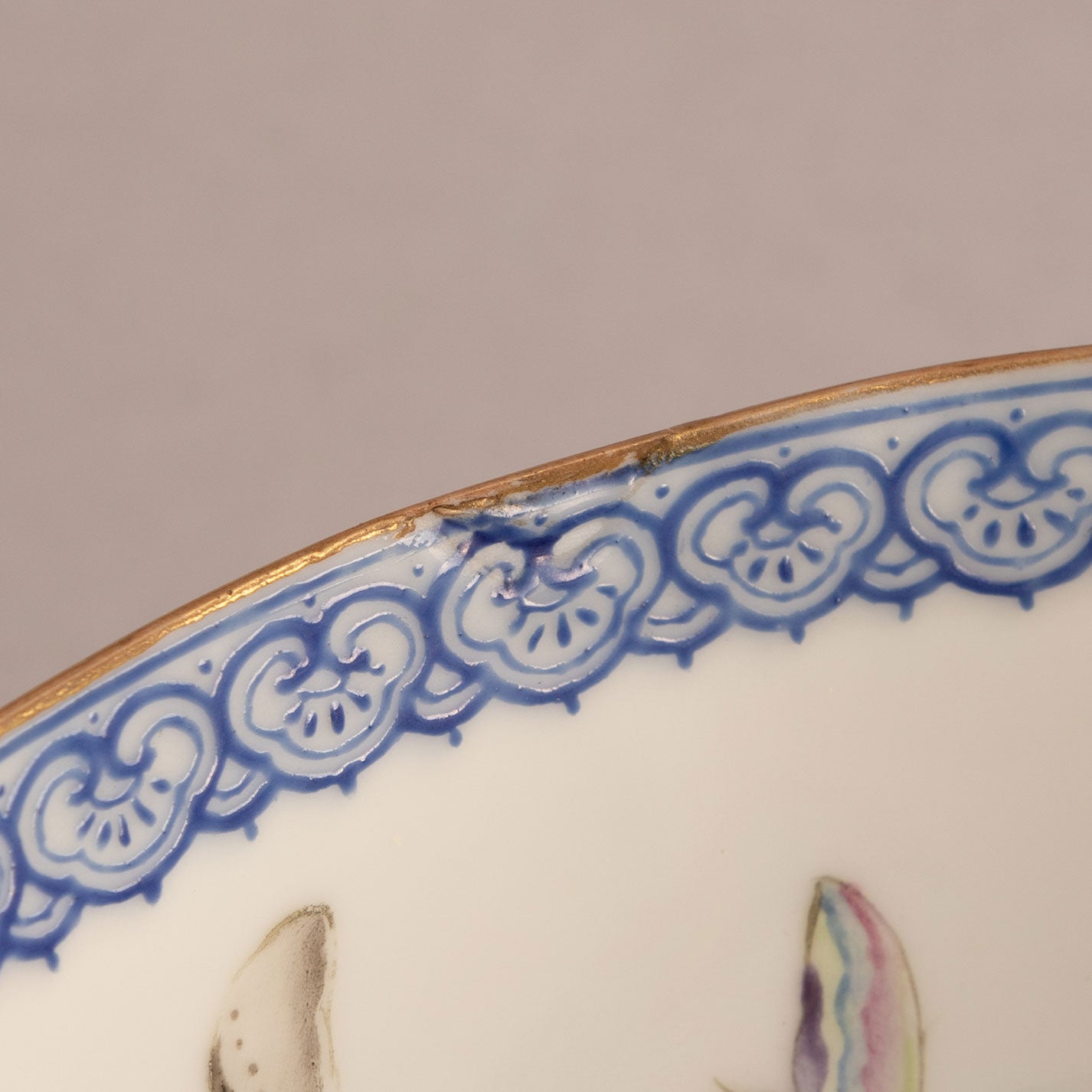A pair of light-colored flower and bird bowls