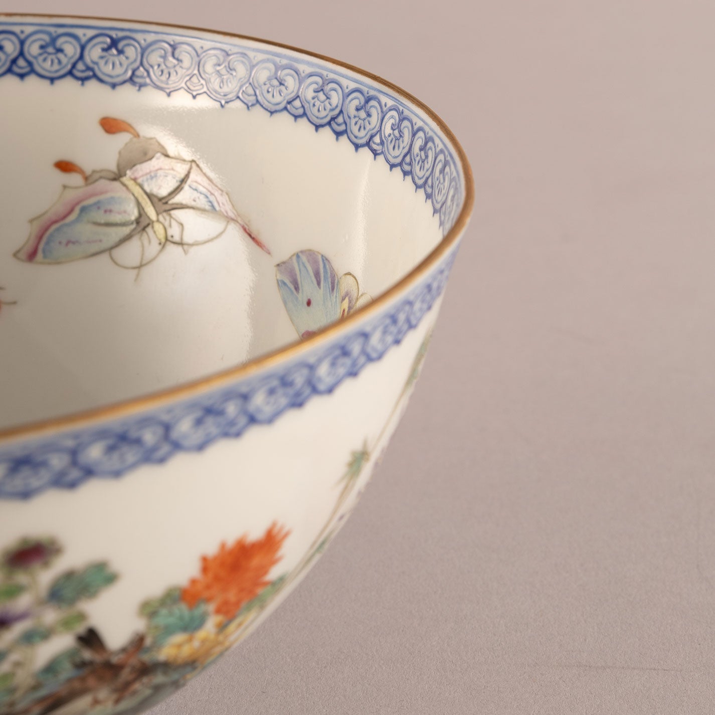 A pair of light-colored flower and bird bowls