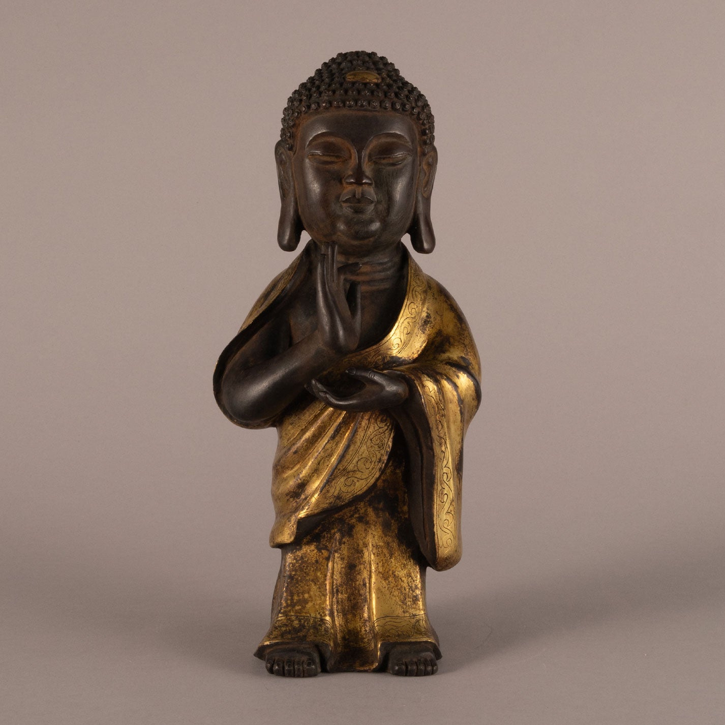 Bronze and gold standing Buddha statue