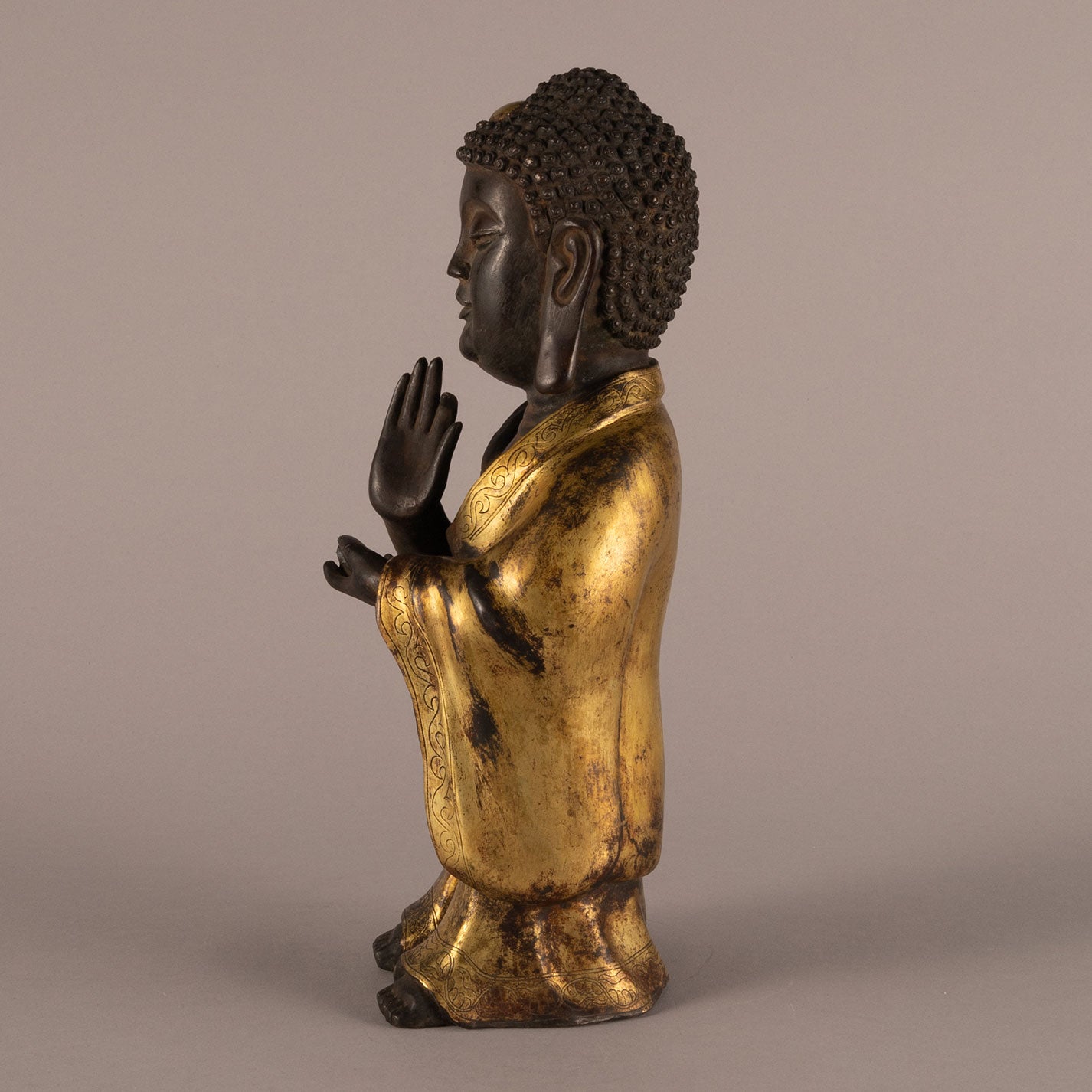 Bronze and gold standing Buddha statue