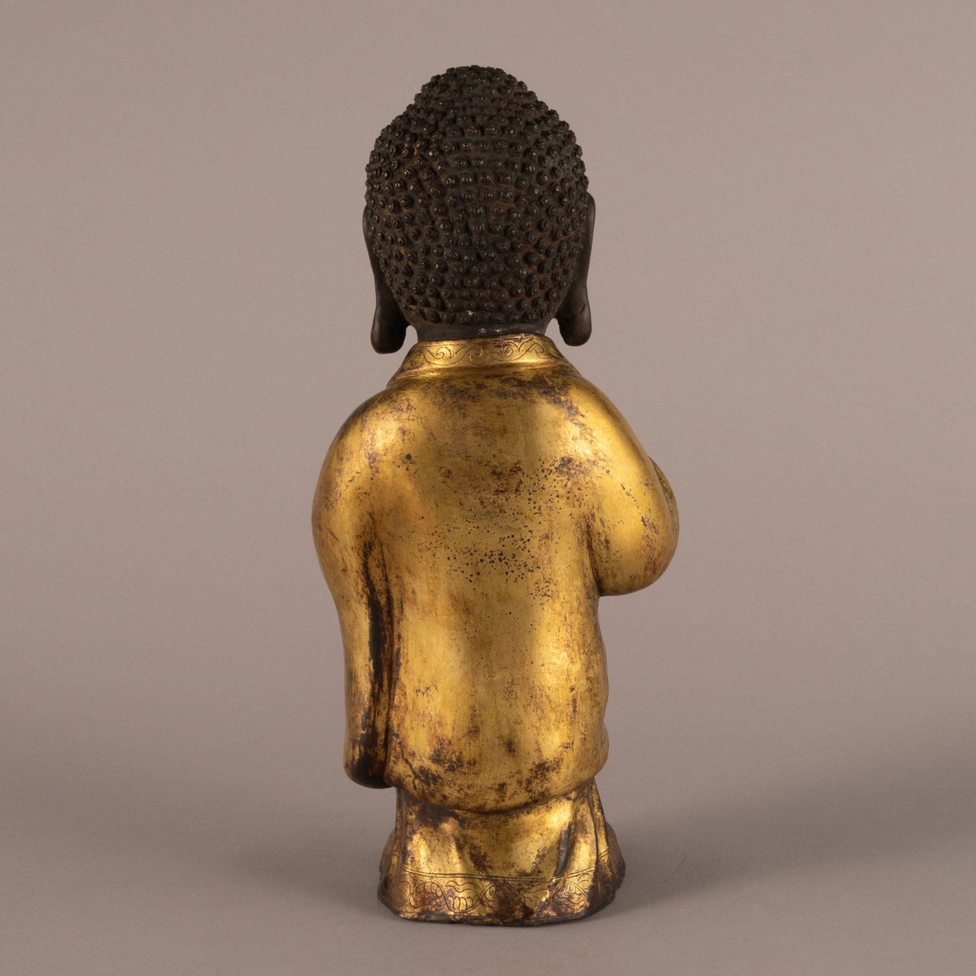 Bronze and gold standing Buddha statue