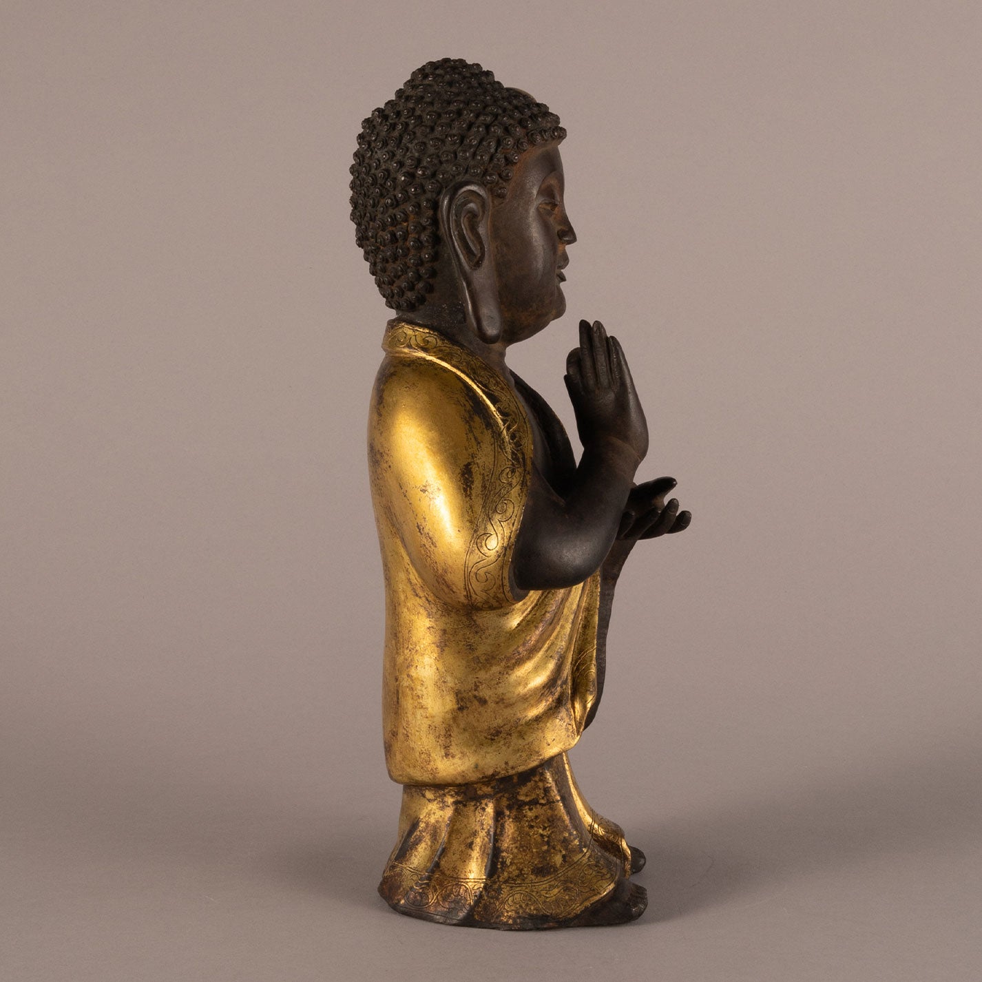 Bronze and gold standing Buddha statue