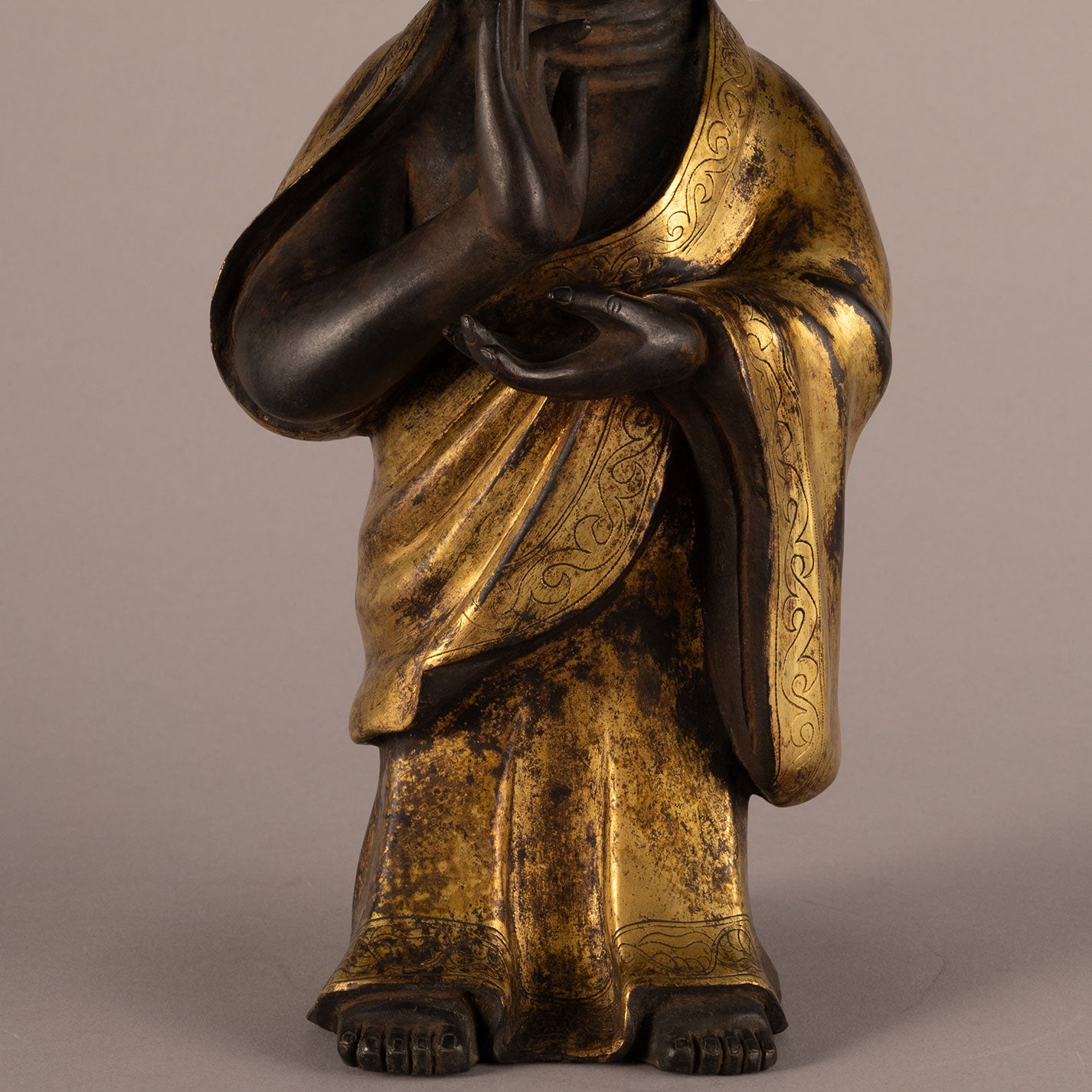 Bronze and gold standing Buddha statue