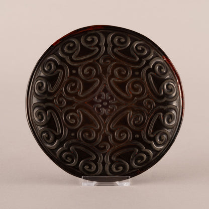 Carved rhinoceros crest plate