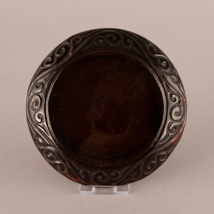 Carved rhinoceros crest plate