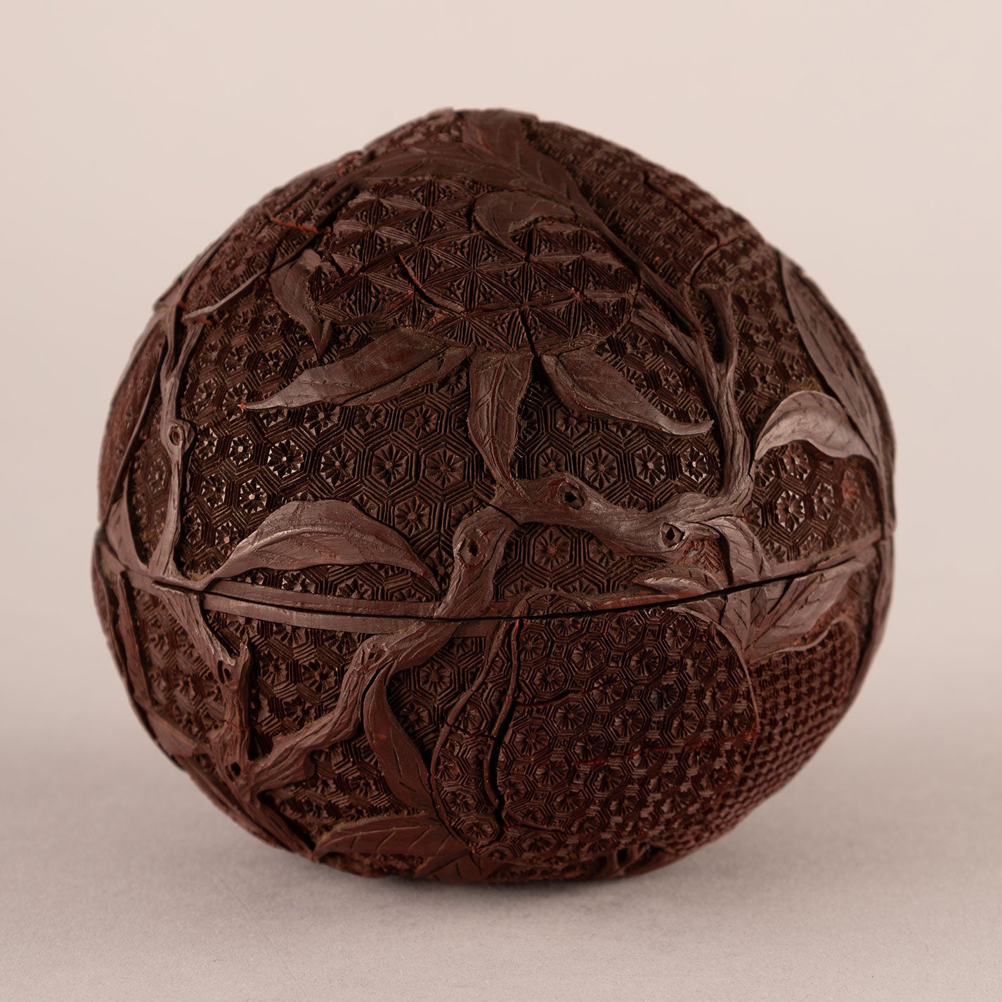 Carved red peach-shaped box with lid