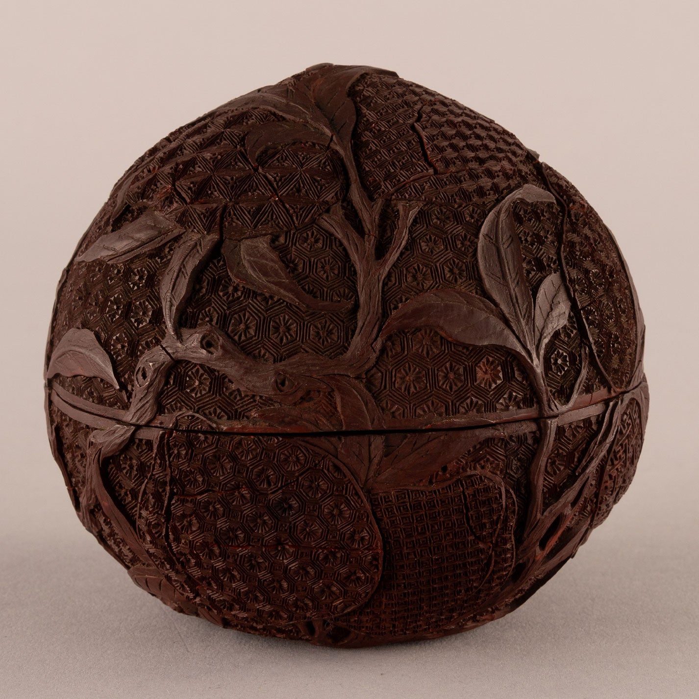 Carved red peach-shaped box with lid