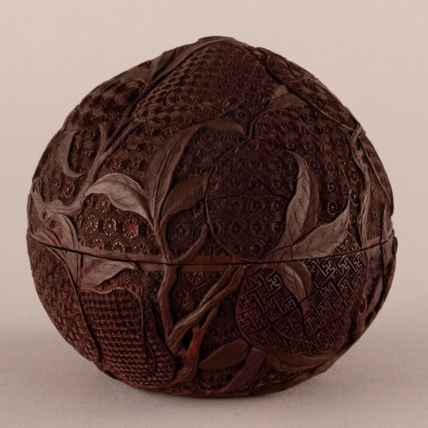 Carved red peach-shaped box with lid