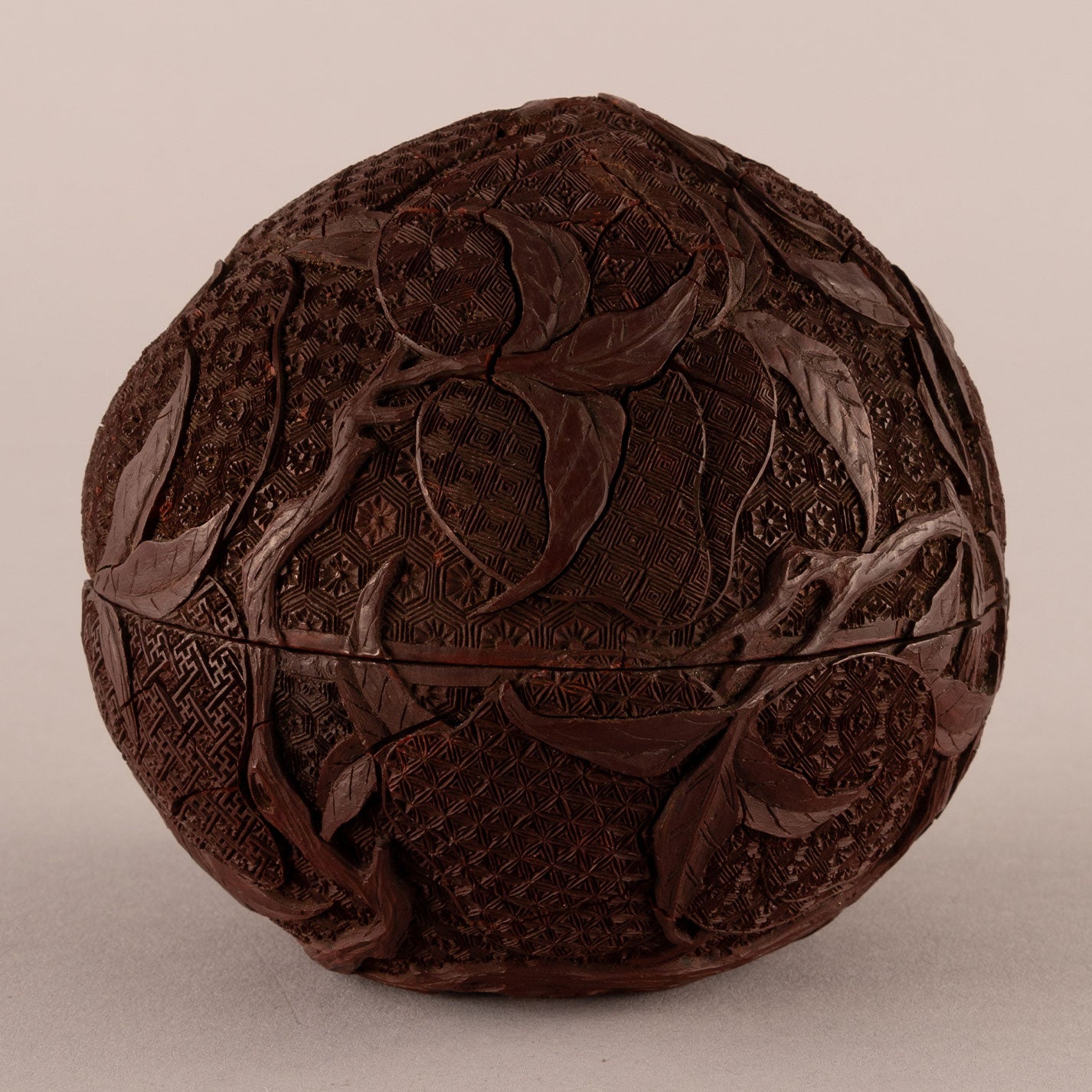 Carved red peach-shaped box with lid