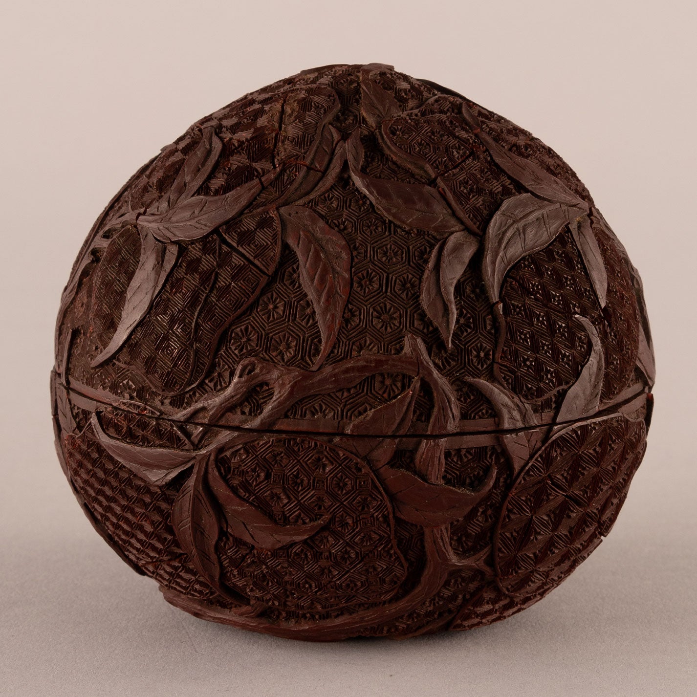 Carved red peach-shaped box with lid