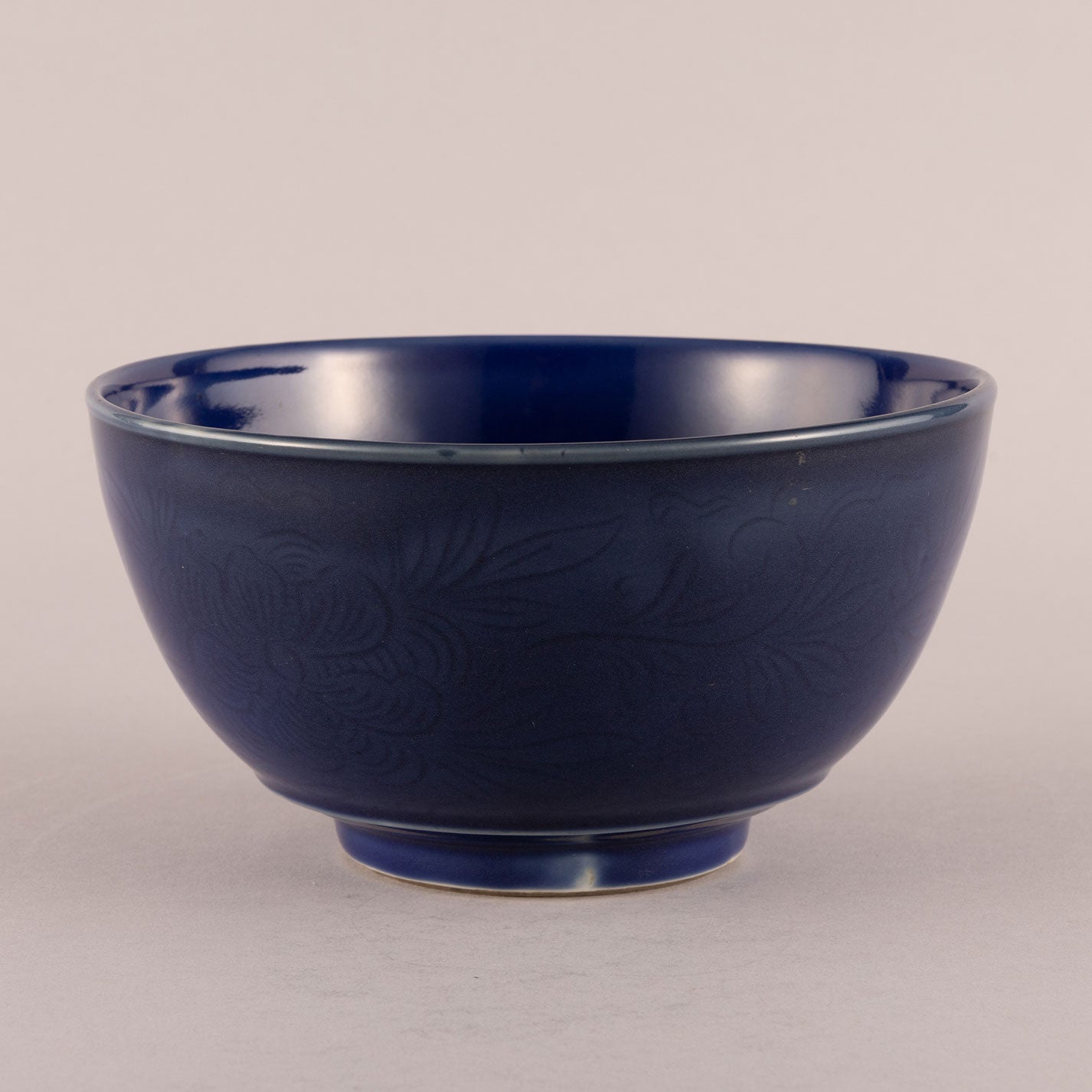 Blue glaze bowl with engraved floral motif